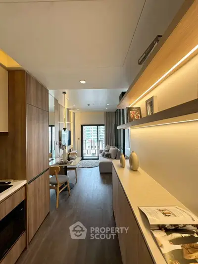 Modern living room with stylish decor and open layout, featuring wooden accents and natural light.