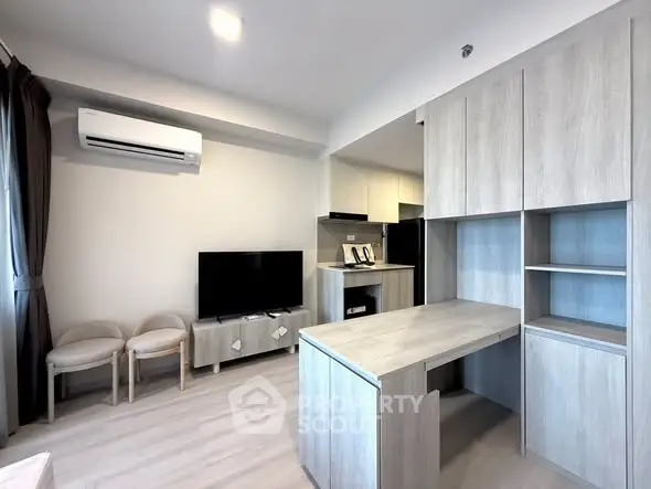 Modern living room with open kitchen and stylish wooden cabinetry