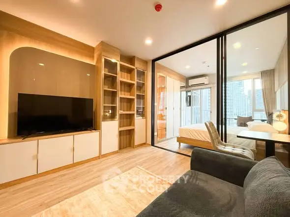 Modern living room with open layout and city view, featuring stylish furniture and natural light.
