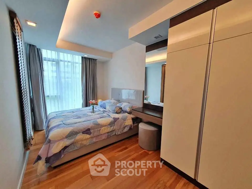 Modern bedroom with cozy decor and ample natural light