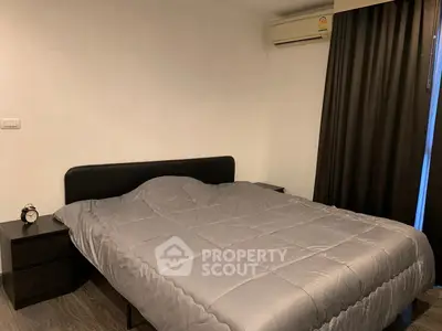Modern bedroom with sleek design, featuring a comfortable bed and stylish decor.