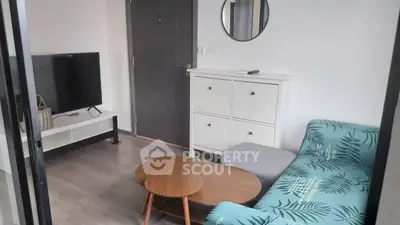 Modern living room with stylish furniture and TV setup, perfect for cozy relaxation.