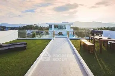 Luxurious rooftop with stunning mountain views and elegant outdoor seating area.