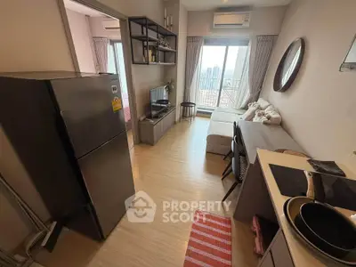 Modern apartment interior with open layout, featuring a cozy living area and compact kitchen.