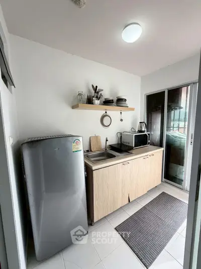 Compact kitchen with modern appliances and sleek design