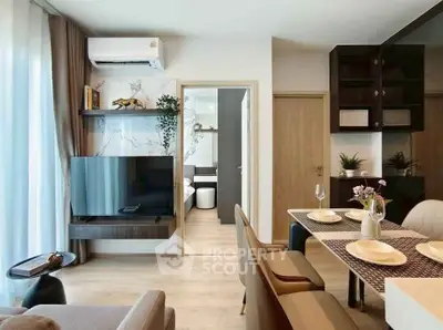 Modern living room with stylish decor and open dining area in a contemporary apartment.