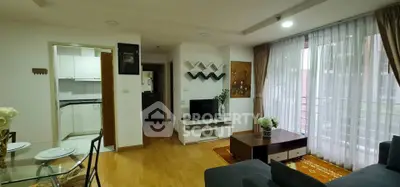 Modern living room with open kitchen and balcony view