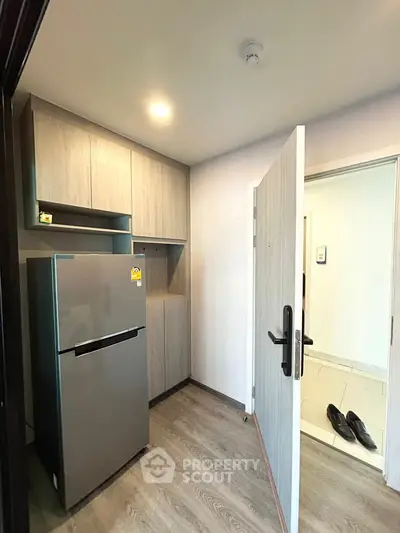 Modern kitchen with sleek fridge and ample storage space