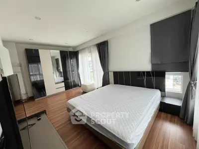 Spacious modern bedroom with large windows and stylish decor