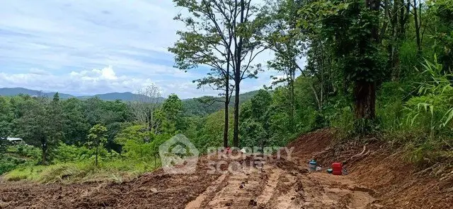Scenic land plot with lush greenery and mountain views, ideal for development or investment.
