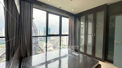 Spacious bedroom with city view and large windows in modern apartment