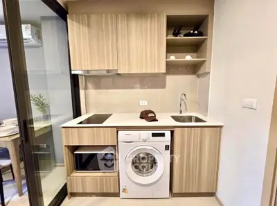 Modern kitchen with integrated appliances and sleek wooden cabinetry