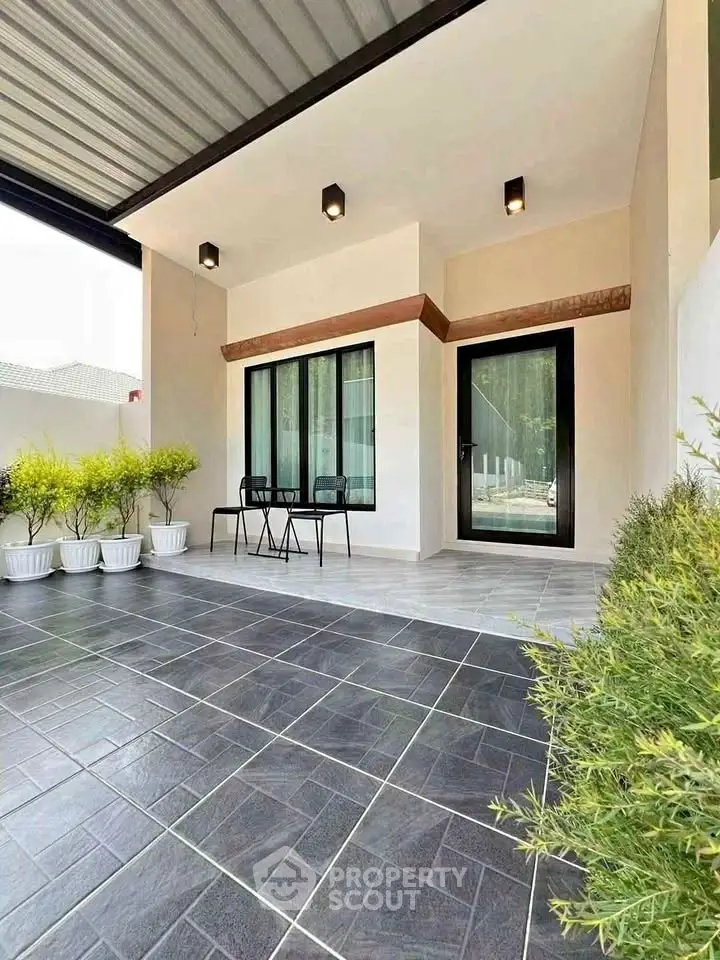 Modern house entrance with stylish patio and seating area