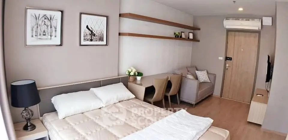Modern studio apartment with cozy bed, stylish decor, and efficient layout for urban living.