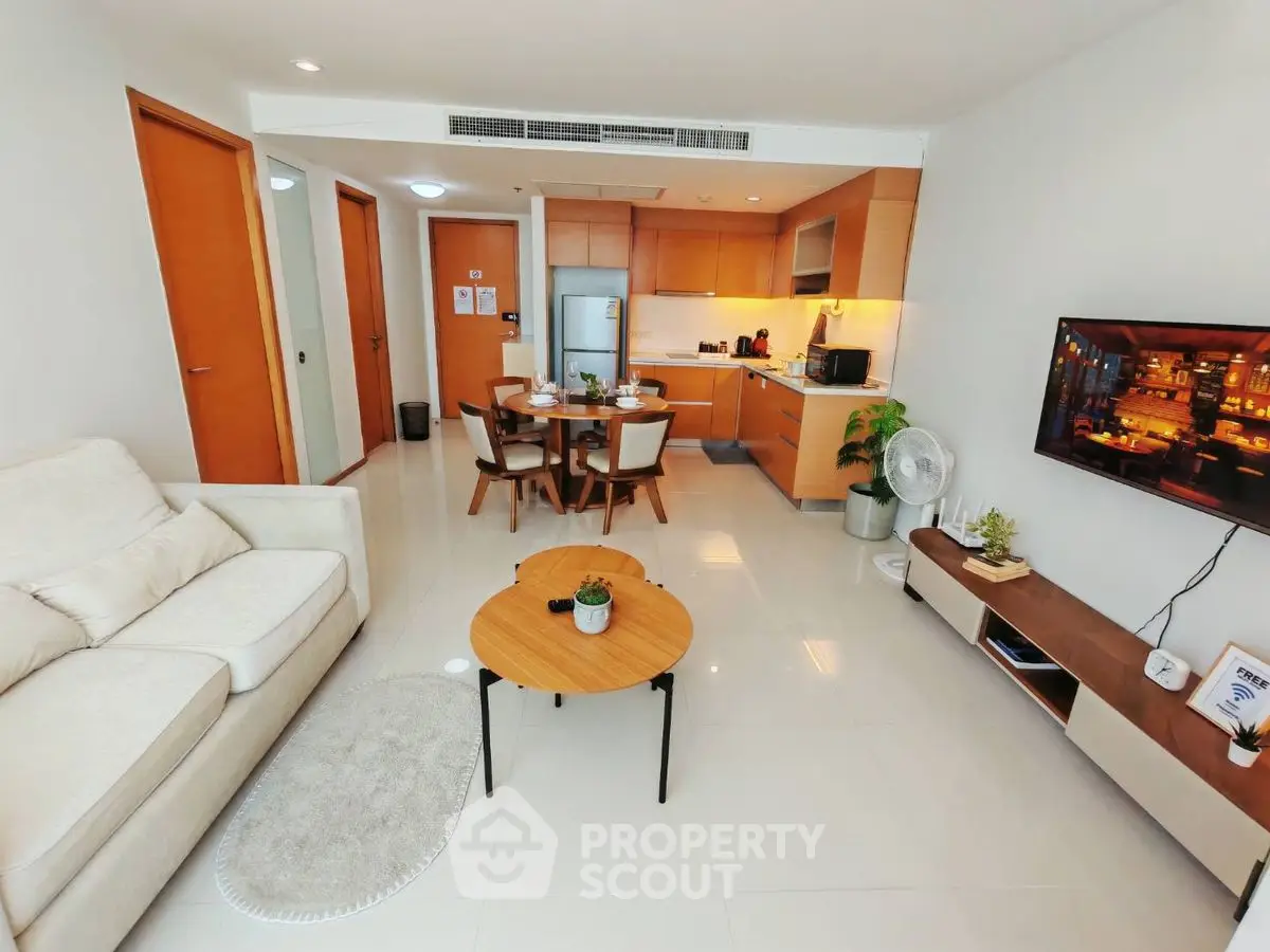Modern open-plan living room with kitchen, stylish furniture, and cozy ambiance.