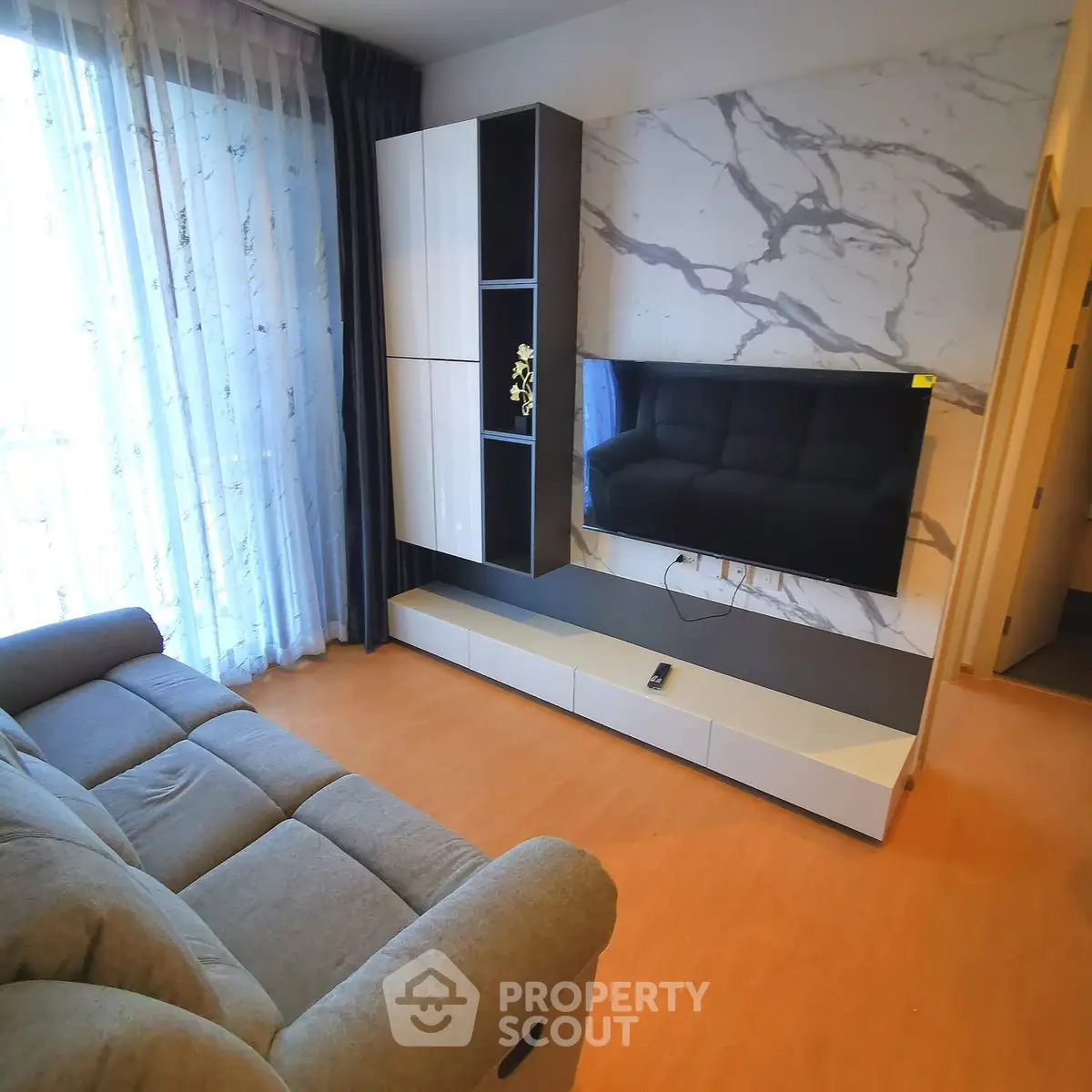 Modern living room with stylish TV setup and cozy sofa