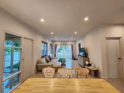 Spacious modern living room with large windows and elegant decor