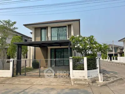 Modern two-story home with a sleek design, featuring a covered carport and a well-manicured front garden, nestled in a tranquil neighborhood.
