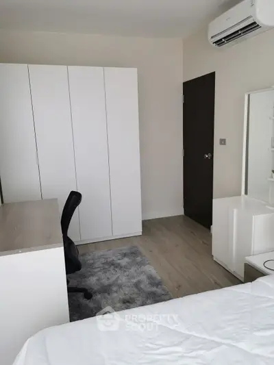 Modern bedroom with sleek furniture and air conditioning, perfect for comfort and style.