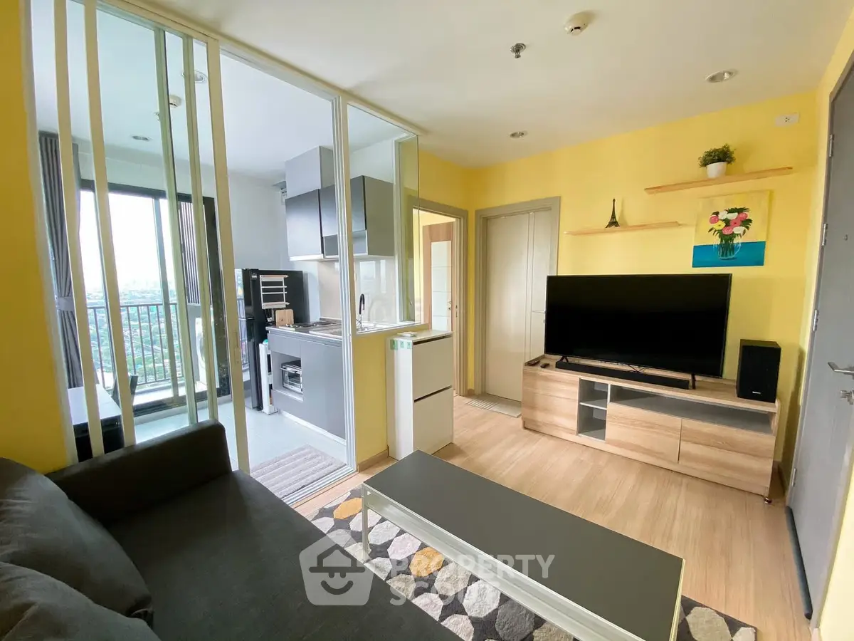Modern living room with open kitchen and balcony view
