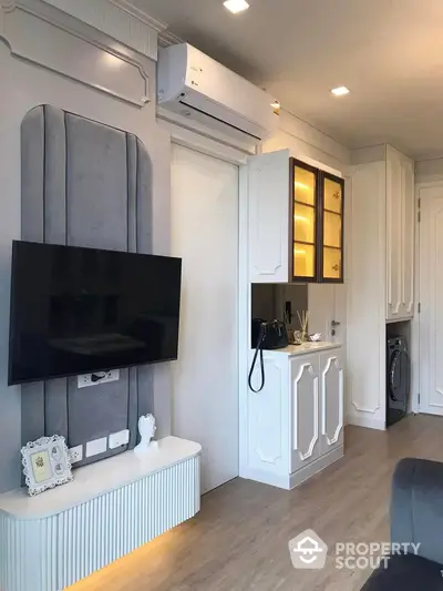 Modern living room with sleek TV setup and elegant cabinetry