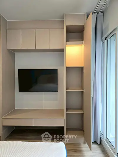 Modern bedroom with built-in storage and wall-mounted TV