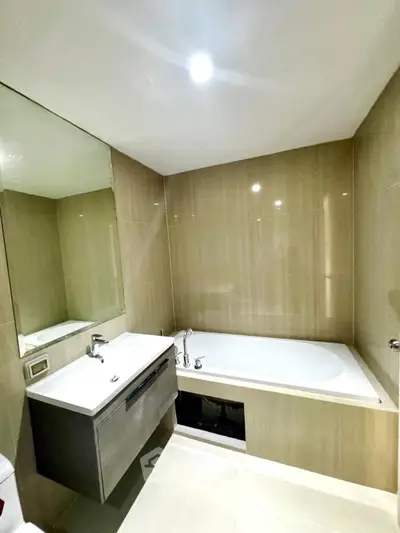 Modern bathroom with sleek design featuring a bathtub and stylish vanity.