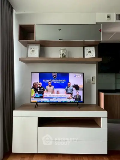Modern living room with sleek TV unit and stylish shelving, perfect for contemporary urban living.