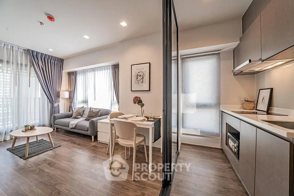 Modern open-plan living room and kitchen with stylish decor and natural light.