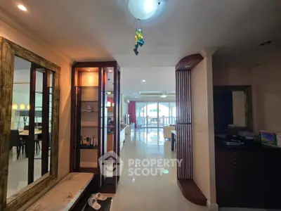 Spacious open-plan living area with modern decor and ample natural light