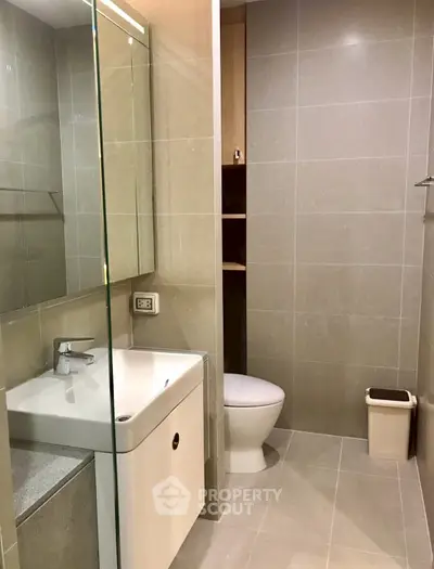 Modern bathroom with sleek fixtures and neutral tiles