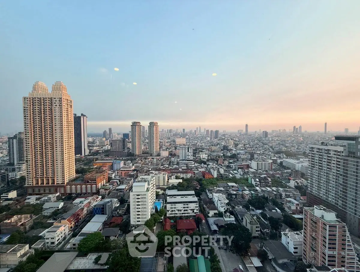 Stunning cityscape view from high-rise apartment at sunset