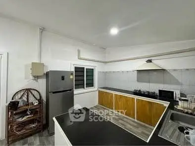 Spacious kitchen with modern appliances and sleek countertops in a contemporary home.