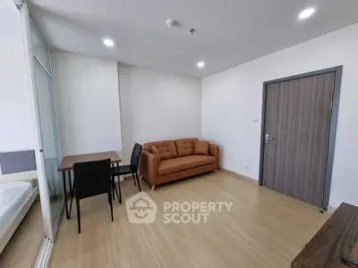 Modern living room with sleek furniture and wooden flooring in a contemporary apartment.