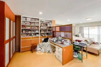Spacious study room with built-in shelves and cozy seating area