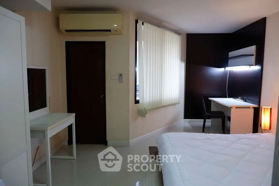 Modern bedroom with sleek desk and ambient lighting