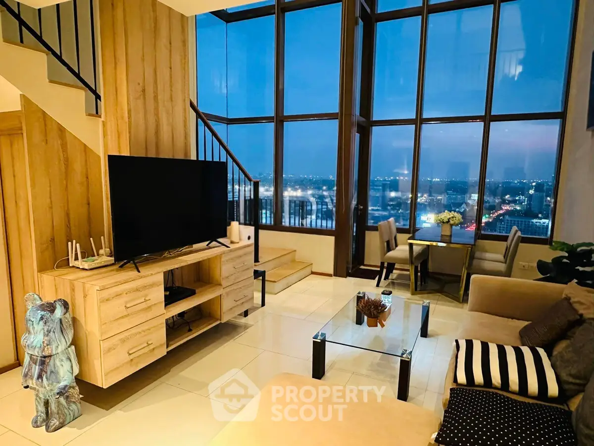 Luxurious living room with stunning city view, high ceilings, and modern decor in a high-rise apartment.