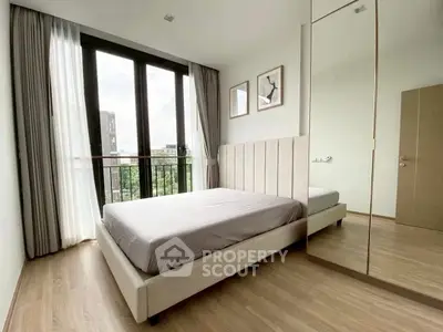 Modern bedroom with large windows and stylish decor in a high-rise apartment.
