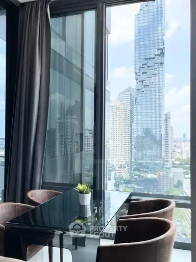 Modern dining area with stunning city view from high-rise apartment.