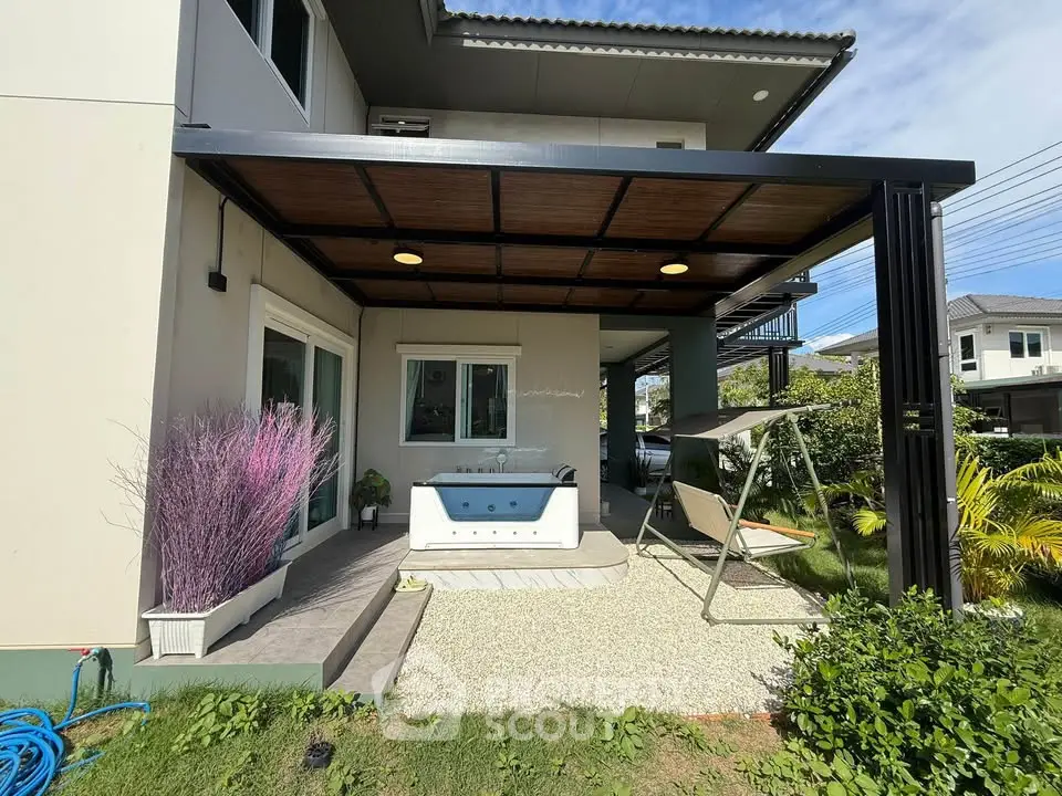 Charming modern home with covered patio and garden swing, perfect for outdoor relaxation.