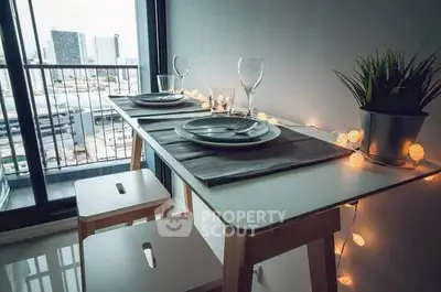 Chic dining setup on a balcony with city view, perfect for urban living.