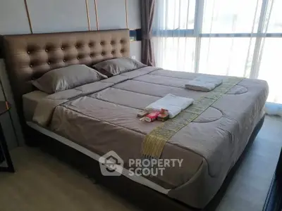Luxurious bedroom with elegant decor and large windows for natural light.