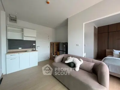 Modern studio apartment with cozy living area and compact kitchen