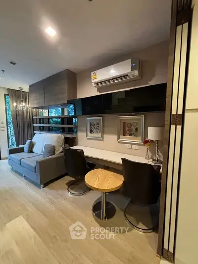 Modern living room with sleek furniture and air conditioning, ideal for urban living.