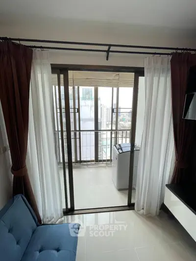 Modern apartment with balcony view and washing machine, featuring elegant curtains and sleek flooring.