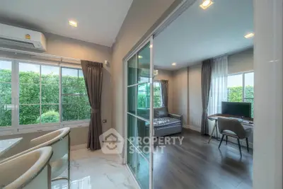 Modern living room with glass sliding doors and garden view