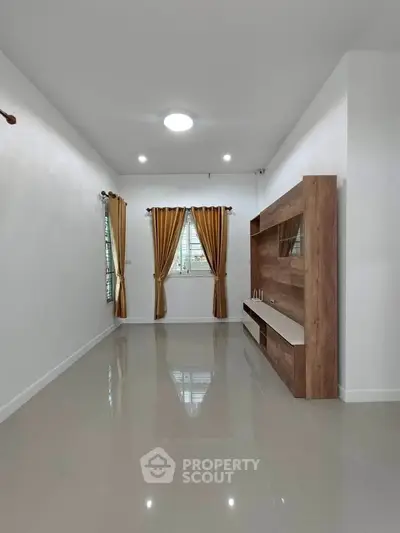 Spacious living room with elegant curtains and modern entertainment unit