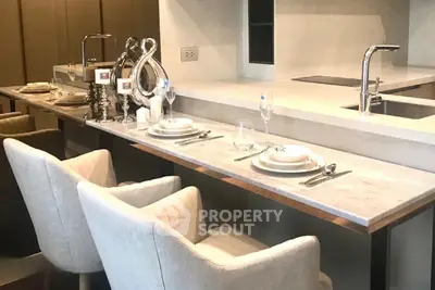 Luxurious modern kitchen with elegant dining setup and sleek countertops