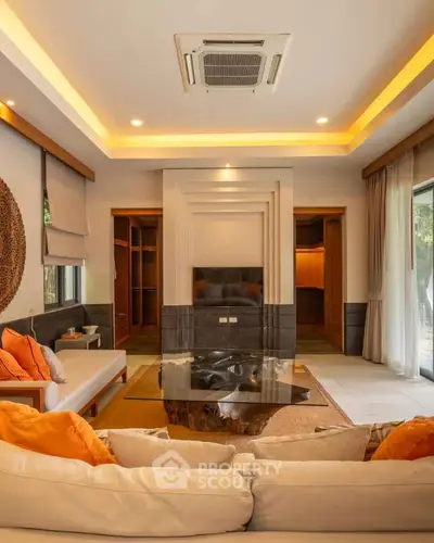 Luxurious living room with modern decor and ambient lighting, featuring a stylish ceiling design and cozy seating area.