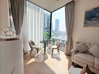 Luxurious modern living room with floor-to-ceiling windows and stunning city view.